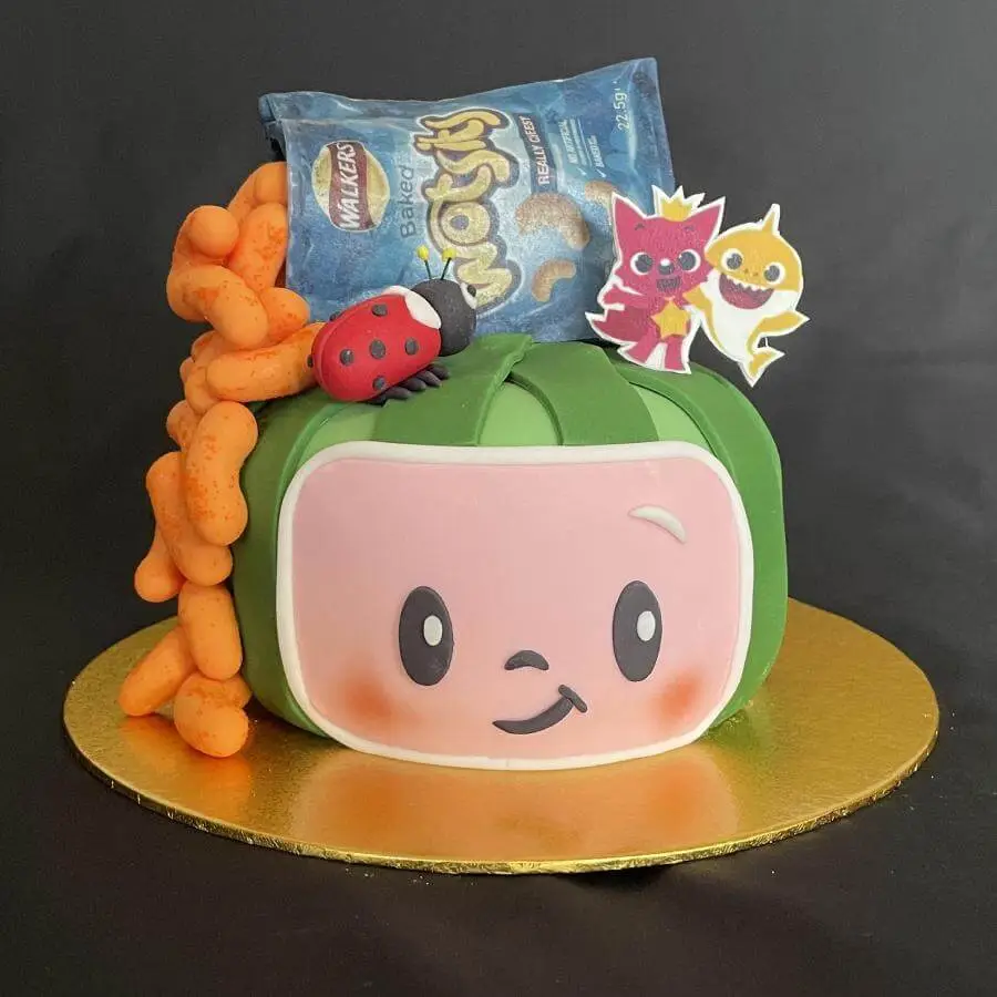 Birthday cake in the shape of a melon with chips on top.