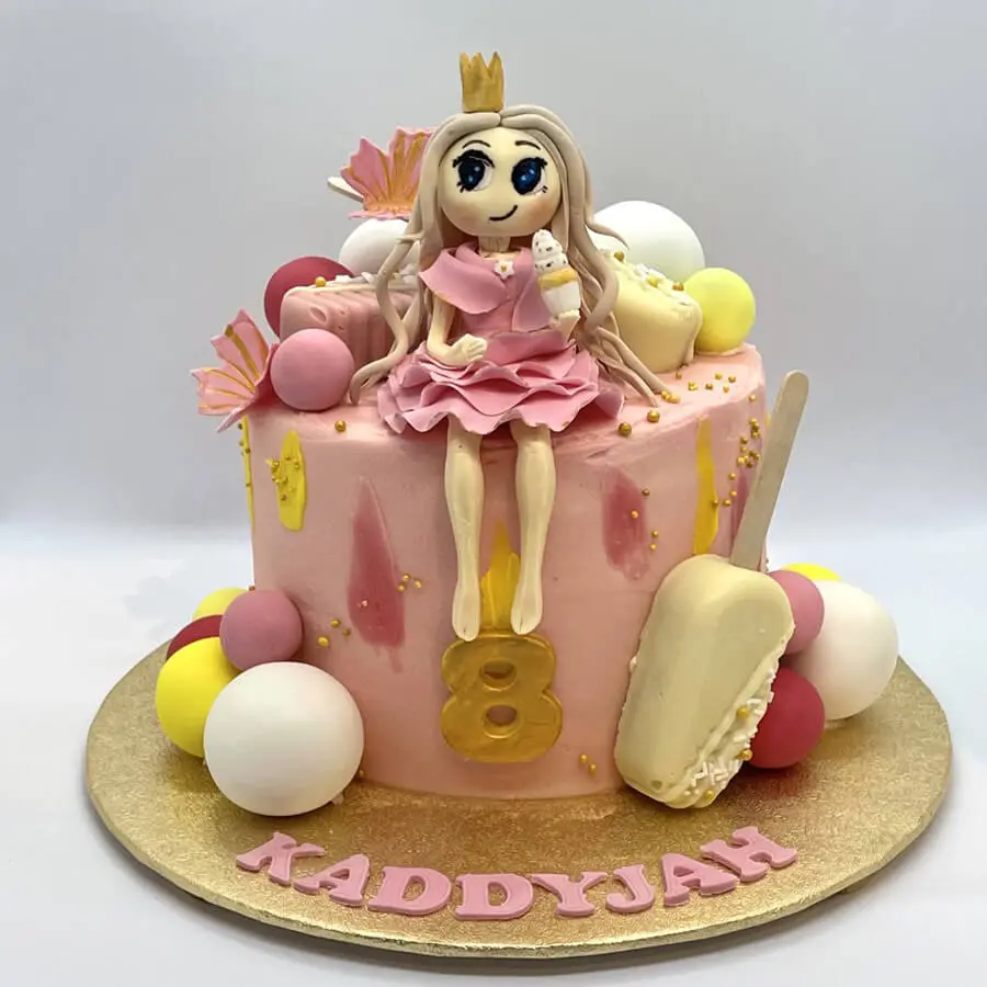 Birthday cake with a princess sitting on it