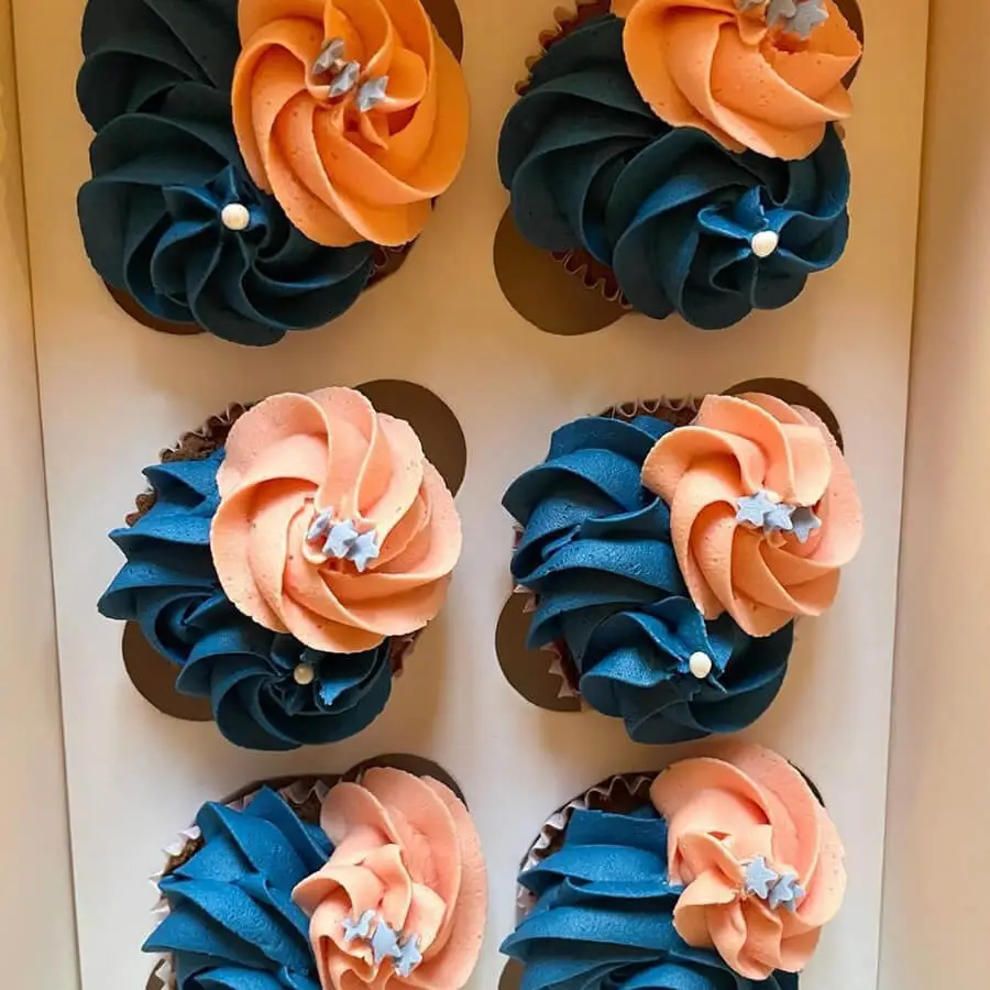 Blue and light orange cupcakes.