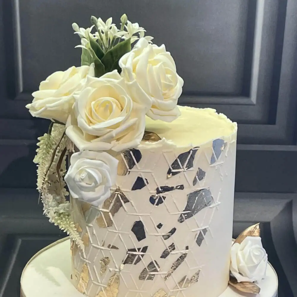 White and silver Mendhi cake with flowers